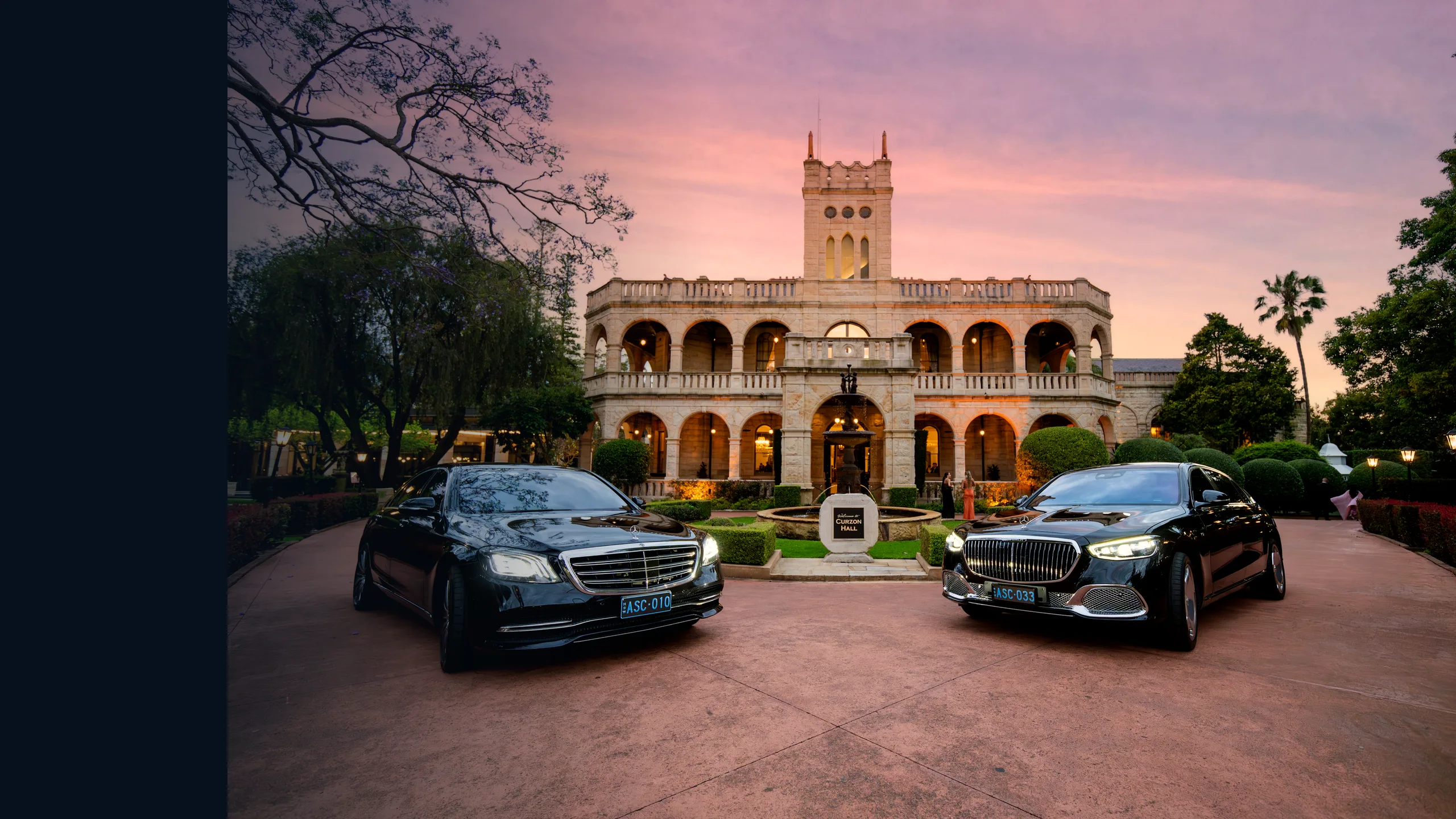 ASChauffeured Mercedes-Benz S-Class L and Mercedes-Maybach S 680 outside a heritage building at dusk