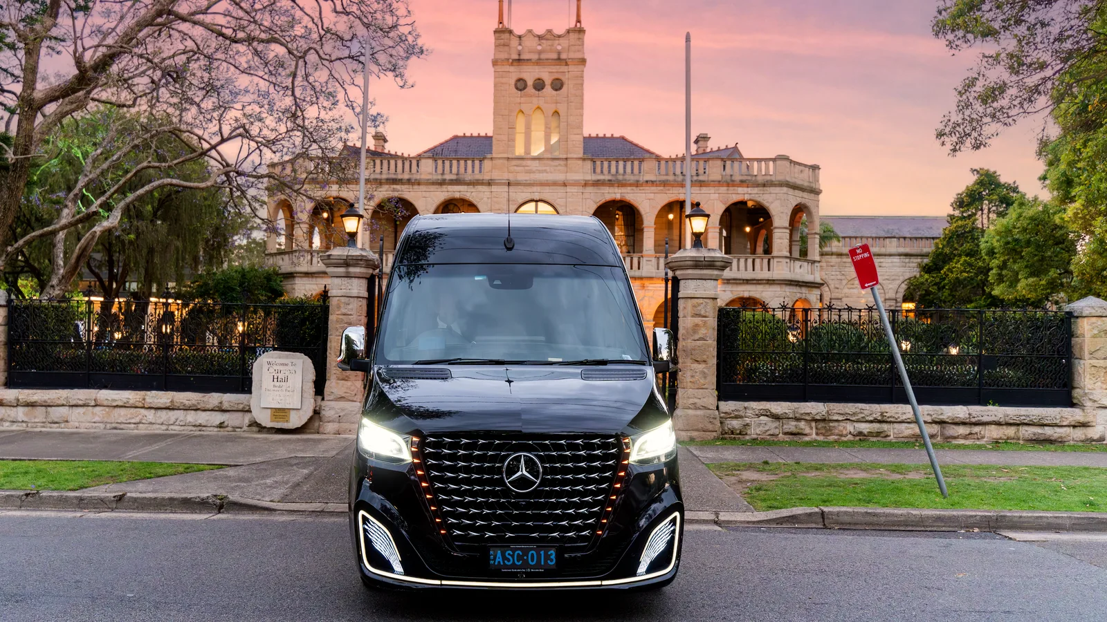 Black ASChauffeured Mercedes-Benz VIP Sprinter exterior outside a heritage building
